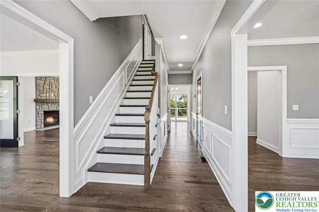 a view of entryway and hall with wooden floor