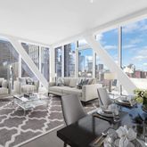 a living room with couches and coffee table with wooden floor