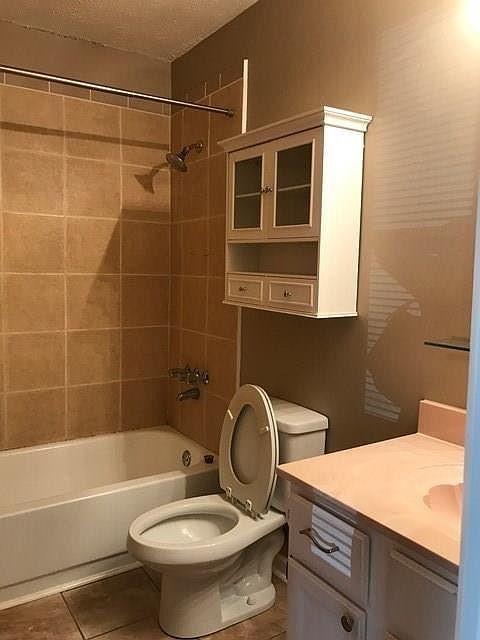 963 Brooklyn Court Norcross, GA 30093 - Photo 13 of 14 a bathroom with a sink toilet and shower