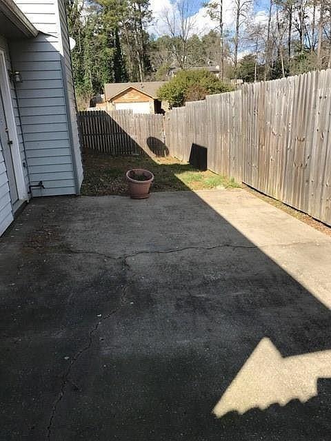 963 Brooklyn Court Norcross, GA 30093 - Photo 14 of 14 a view of a roof deck with wooden fence and a couple of chairs