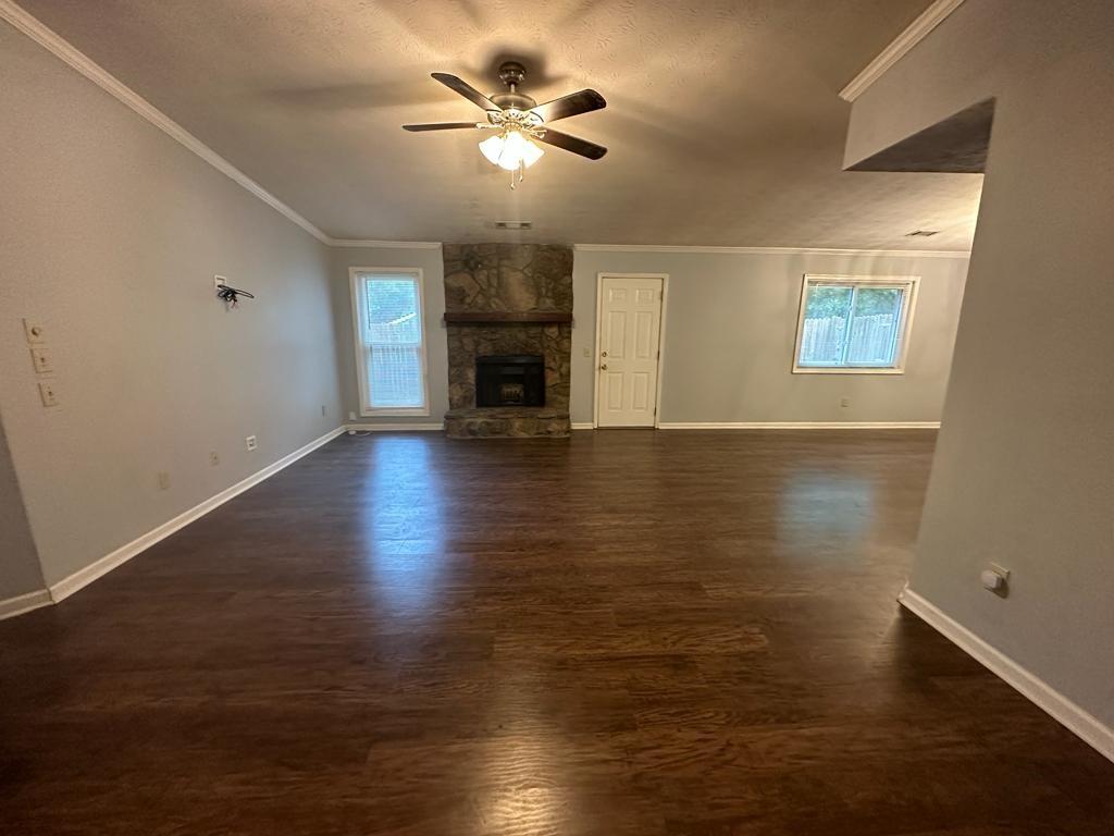 963 Brooklyn Court Norcross, GA 30093 - Photo 3 of 14 an empty room with wooden floor chandelier fan and windows