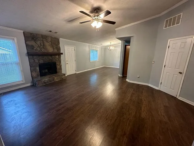 wooden floor in an empty room with a fireplace