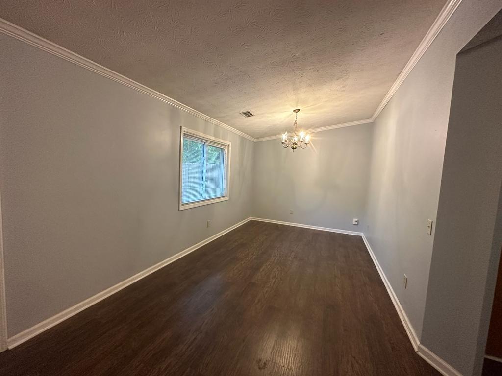 963 Brooklyn Court Norcross, GA 30093 - Photo 7 of 14 an empty room with wooden floor and windows