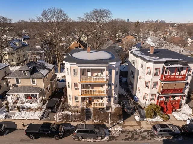 a view of a city that has a lot of cars parked on the road