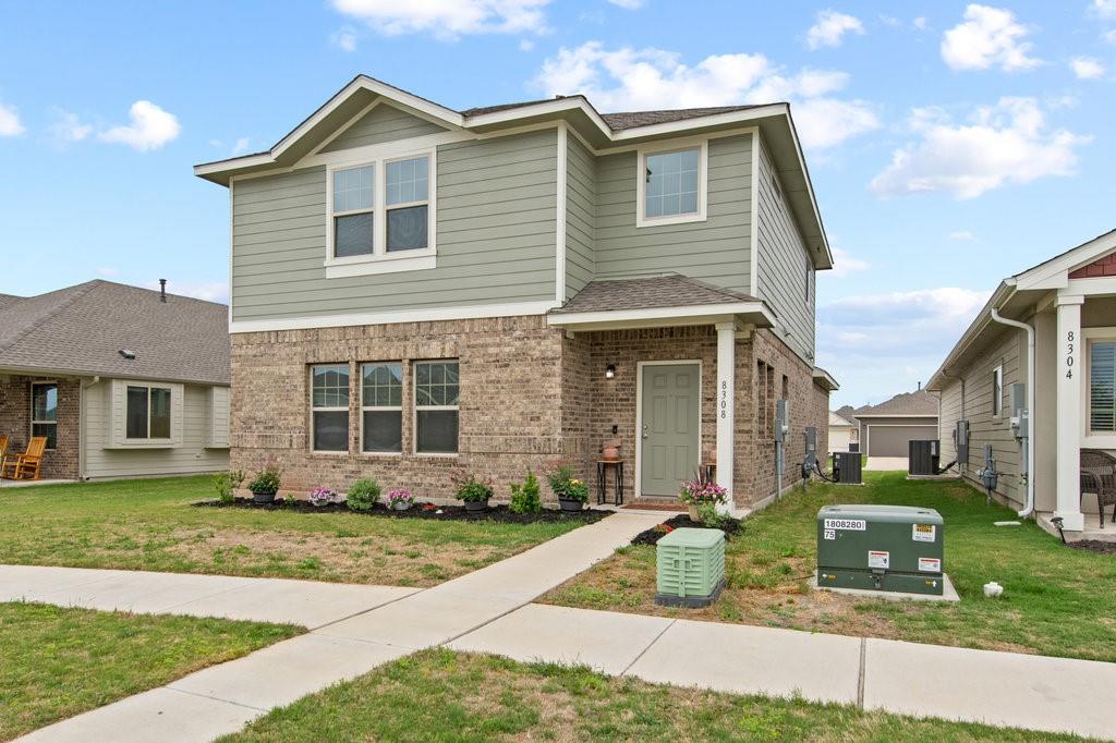 8308 Daisy Cutter Crossing Georgetown, TX 78626 - Photo 2 of 27 A welcoming front exterior showcasing a blend of brick and siding, complemented by a neat lawn.