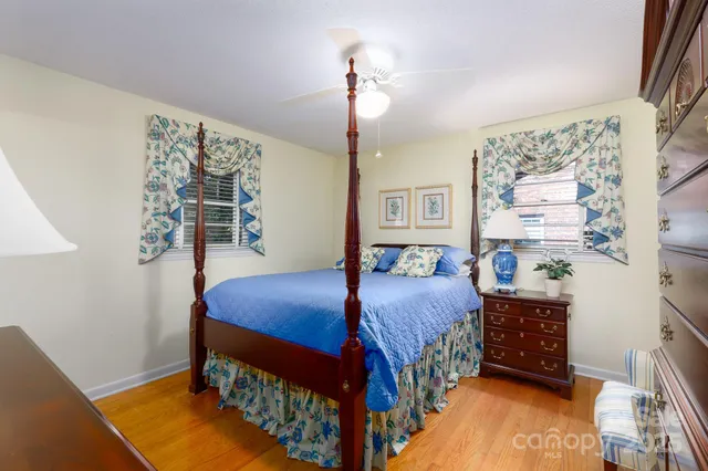 a bedroom with a bed a baby crib and a window