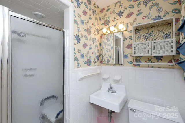 a bathroom with a sink toilet and mirror
