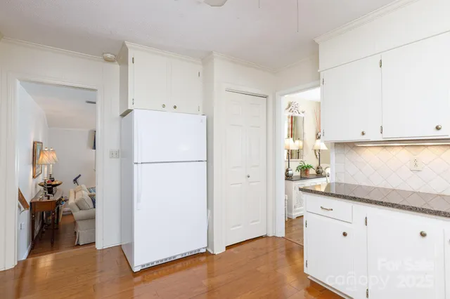 a kitchen with a refrigerator and a stove top oven