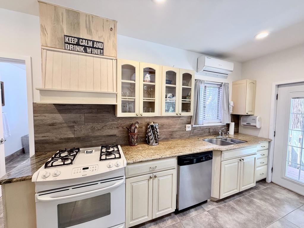 22292 Crestline Road Palomar Mountain, CA 92060 - Photo 29 of 38 a kitchen with a sink stove top oven and cabinets