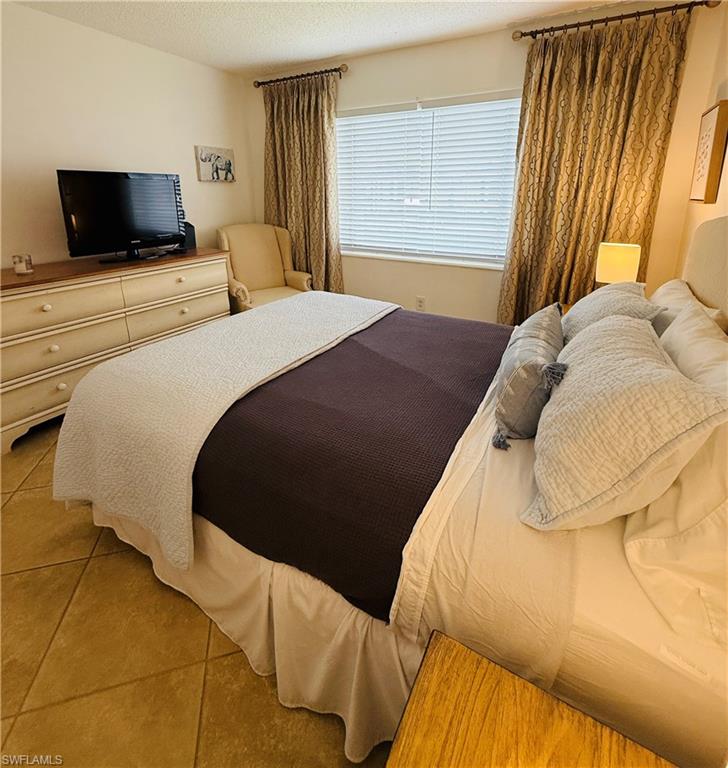 3250 10th Street North, Unit C8 Naples, FL 34103 - Photo 15 of 24 Room featuring ceramic tile flooring, window with blinds, and decorative curtain rods