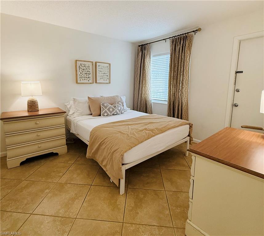 3250 10th Street North, Unit C8 Naples, FL 34103 - Photo 6 of 24 Neutral-toned wall finish with ceramic tile flooring