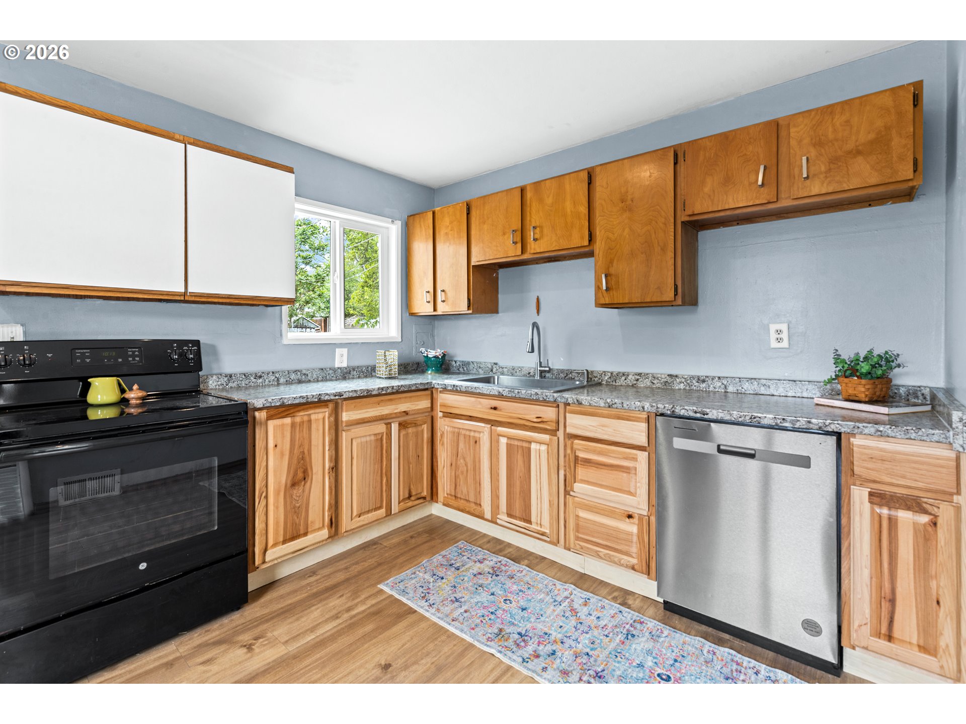 3009 Southwest Isaac Avenue Pendleton, OR 97801 - Photo 9 of 28 a kitchen with stainless steel appliances granite countertop a stove a sink and a microwave