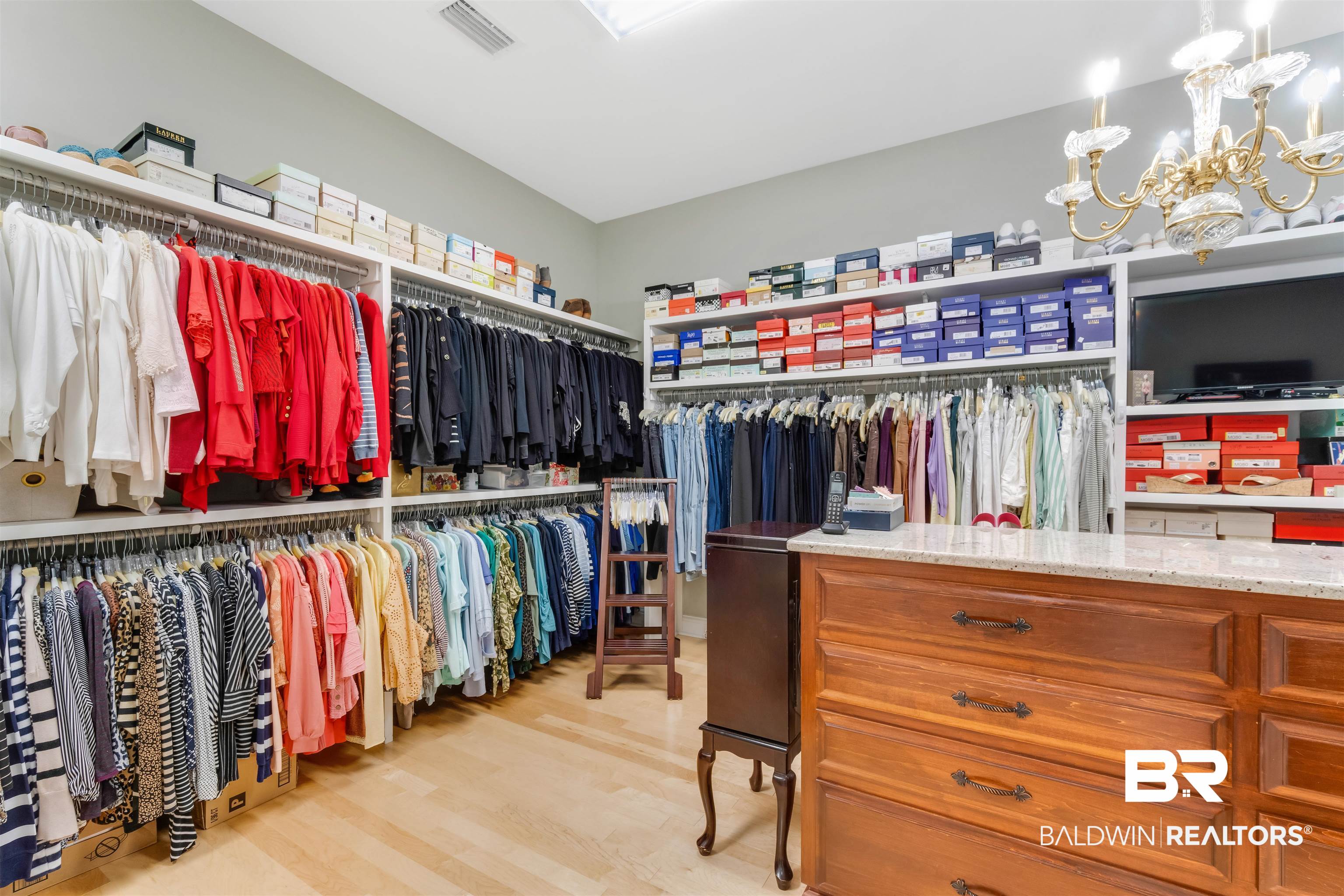 11281 Redfern Road Daphne, AL 36526 - Photo 37 of 80 Walk in closet featuring light wood-type flooring and an inviting chandelier