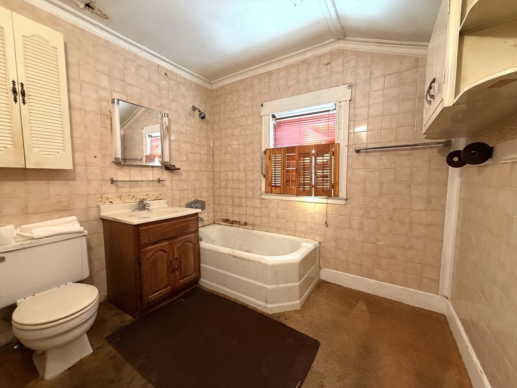 386 June Street Worcester, MA 01602 - Photo 11 of 16 a bathroom with a sink a toilet and shower