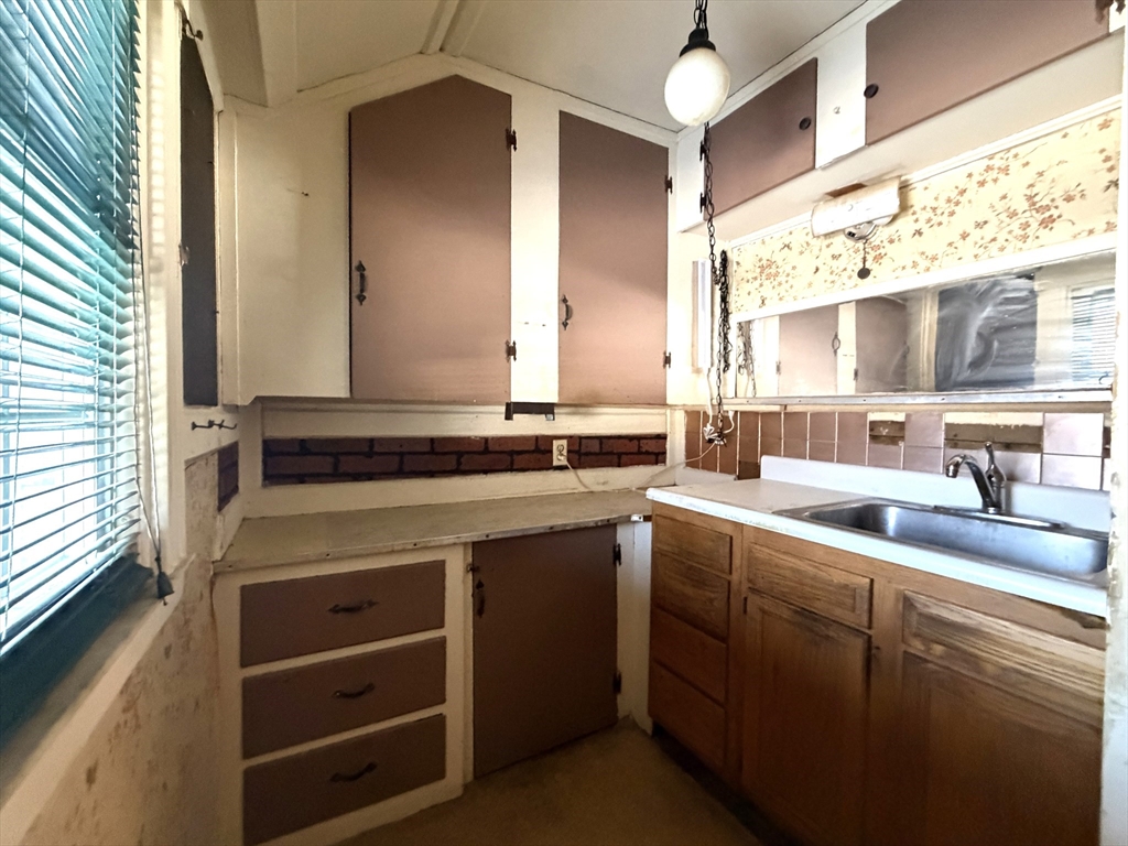 386 June Street Worcester, MA 01602 - Photo 5 of 16 a kitchen with a sink and cabinets