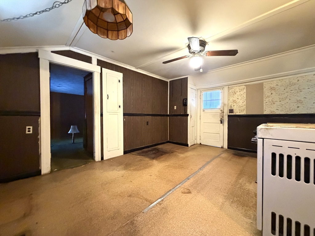 386 June Street Worcester, MA 01602 - Photo 6 of 16 a view of a livingroom with a ceiling fan and kitchen view