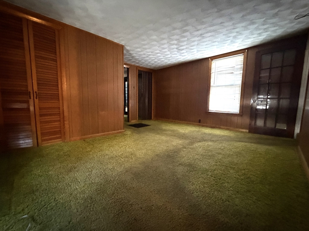 386 June Street Worcester, MA 01602 - Photo 7 of 16 a view of an empty room with window and stairs