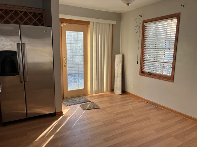 an empty room with window and a bathroom