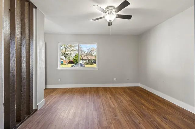 wooden floor in an empty room with a window