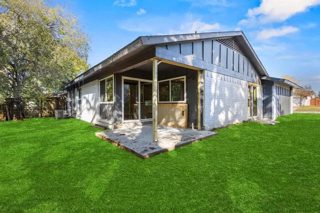 a front view of house with backyard and green space