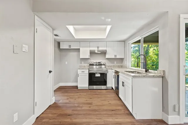 a kitchen with a stove a sink and a refrigerator