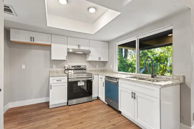 a kitchen with a stove a sink and a refrigerator
