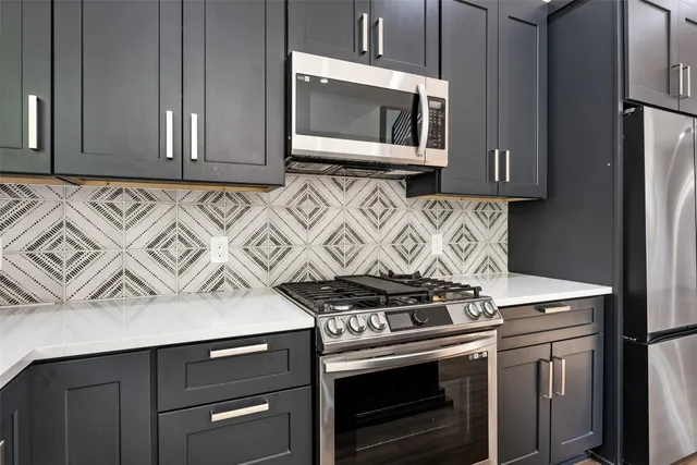 a kitchen with wooden cabinets and a stove top oven