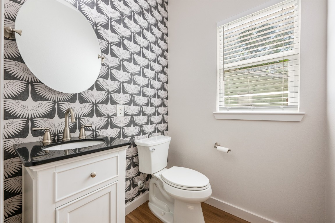 3010 Webberville Road, Unit 1 Austin, TX 78702 - Photo 21 of 40 a bathroom with a sink a toilet and a mirror