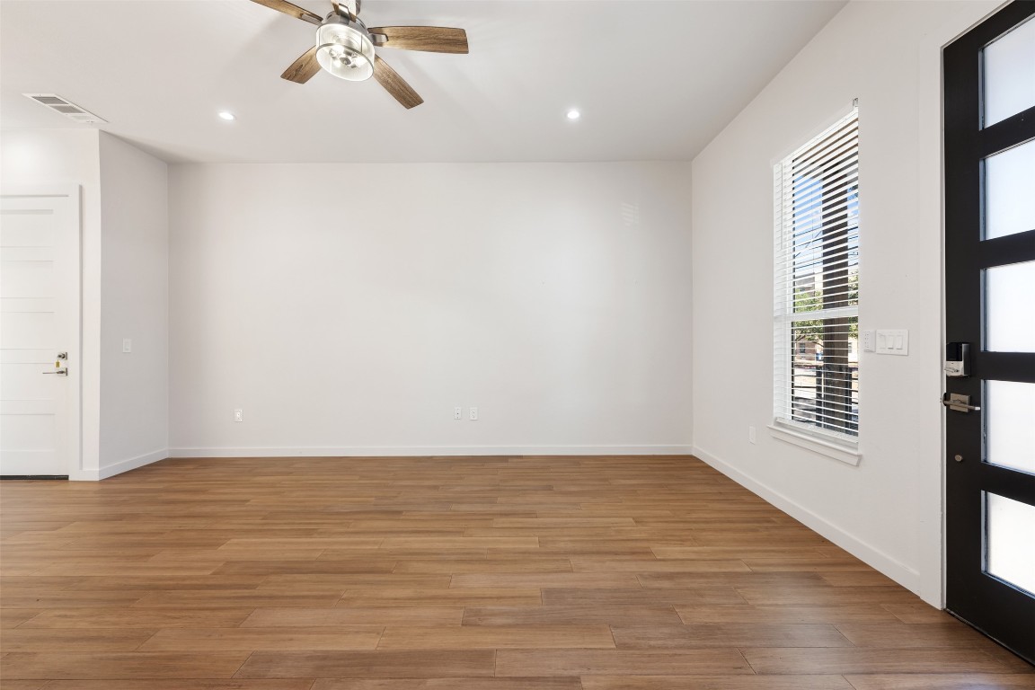 3010 Webberville Road, Unit 1 Austin, TX 78702 - Photo 5 of 40 a view of an empty room with wooden floor and a window