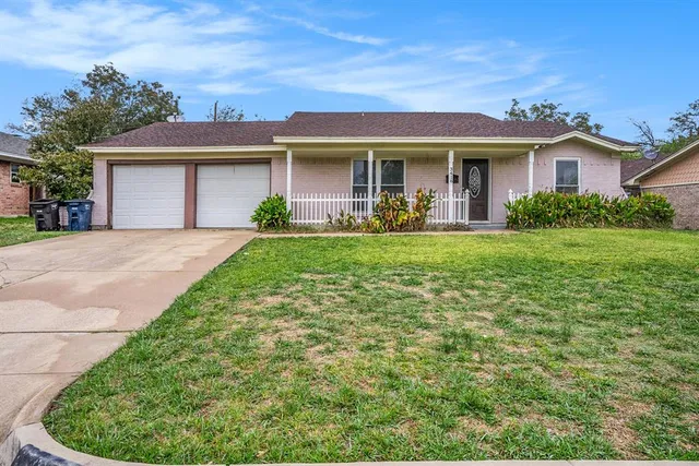 a front view of a house with a yard and porch