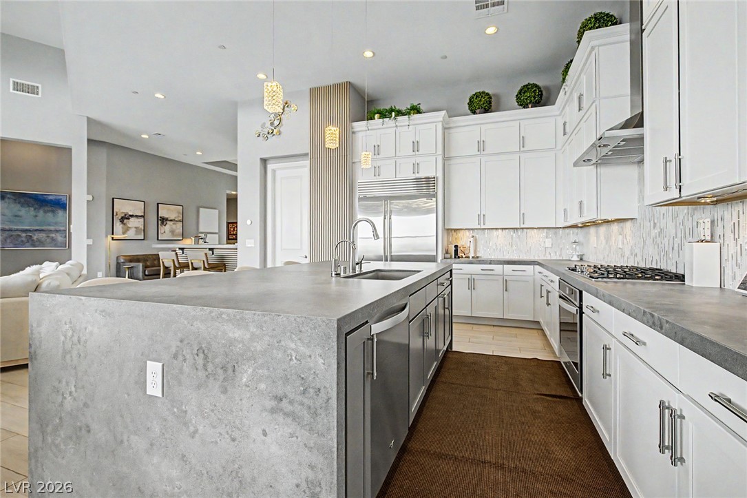 6014 Willow Ridge Court Las Vegas, NV 89135 - Photo 33 of 99 This open concept kitchen features sleek countertops, modern appliances, and a seamless flow into the living area.