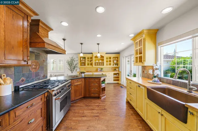a kitchen with stainless steel appliances a sink and a large window