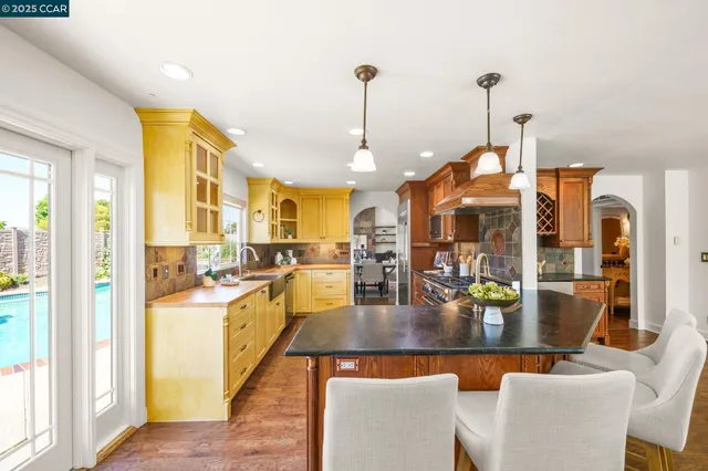 a very nice looking dining room with a dining table chairs and couches