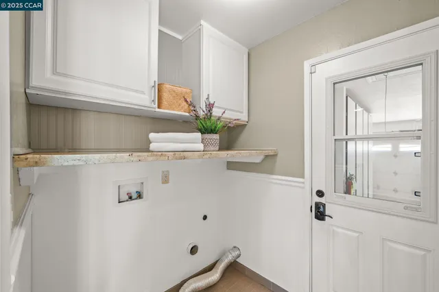 a bathroom with a granite countertop sink toilet and mirror