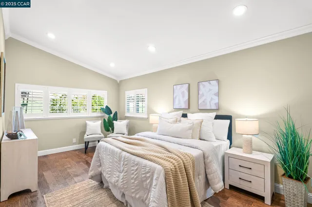 a bedroom with a bed and a large window