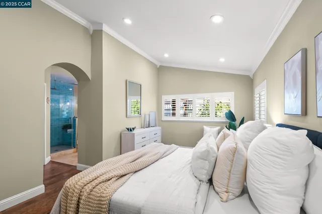 a view of an empty room with wooden floor and cabinet