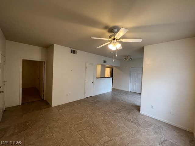 7255 West Sunset Road, Unit 1124 Las Vegas, NV 89113 - Photo 9 of 18 Polished tile flooring spans an airy open-concept living area with classic neutral walls.