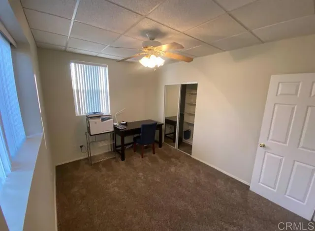 a view of a livingroom with furniture and a window