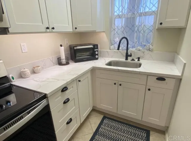 a kitchen with a sink stove and cabinets