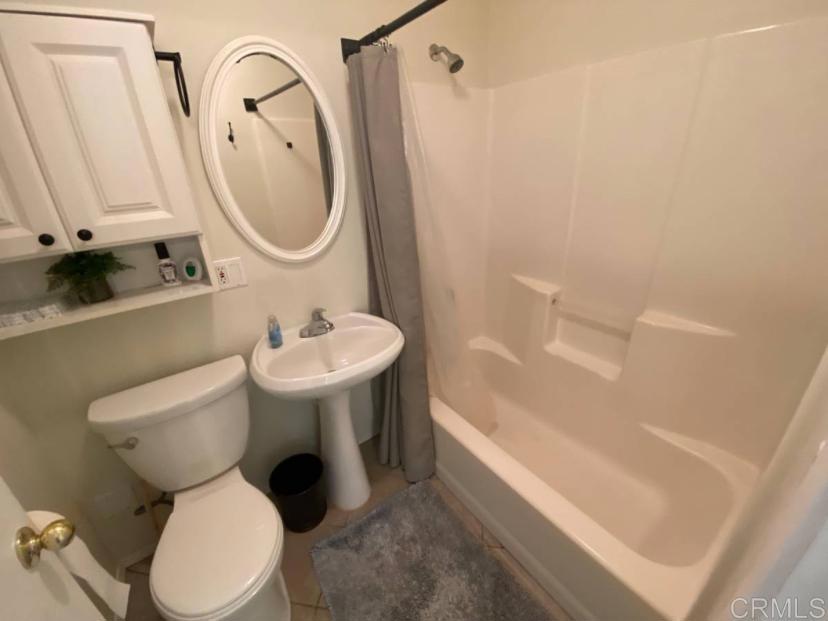 2426 Suncrest Boulevard, Unit B El Cajon, CA 92021 - Photo 9 of 17 a bathroom with a sink toilet and a mirror