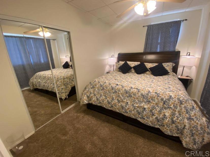 2426 Suncrest Boulevard, Unit B El Cajon, CA 92021 - Photo 10 of 17 a bedroom with a bed and wooden floor