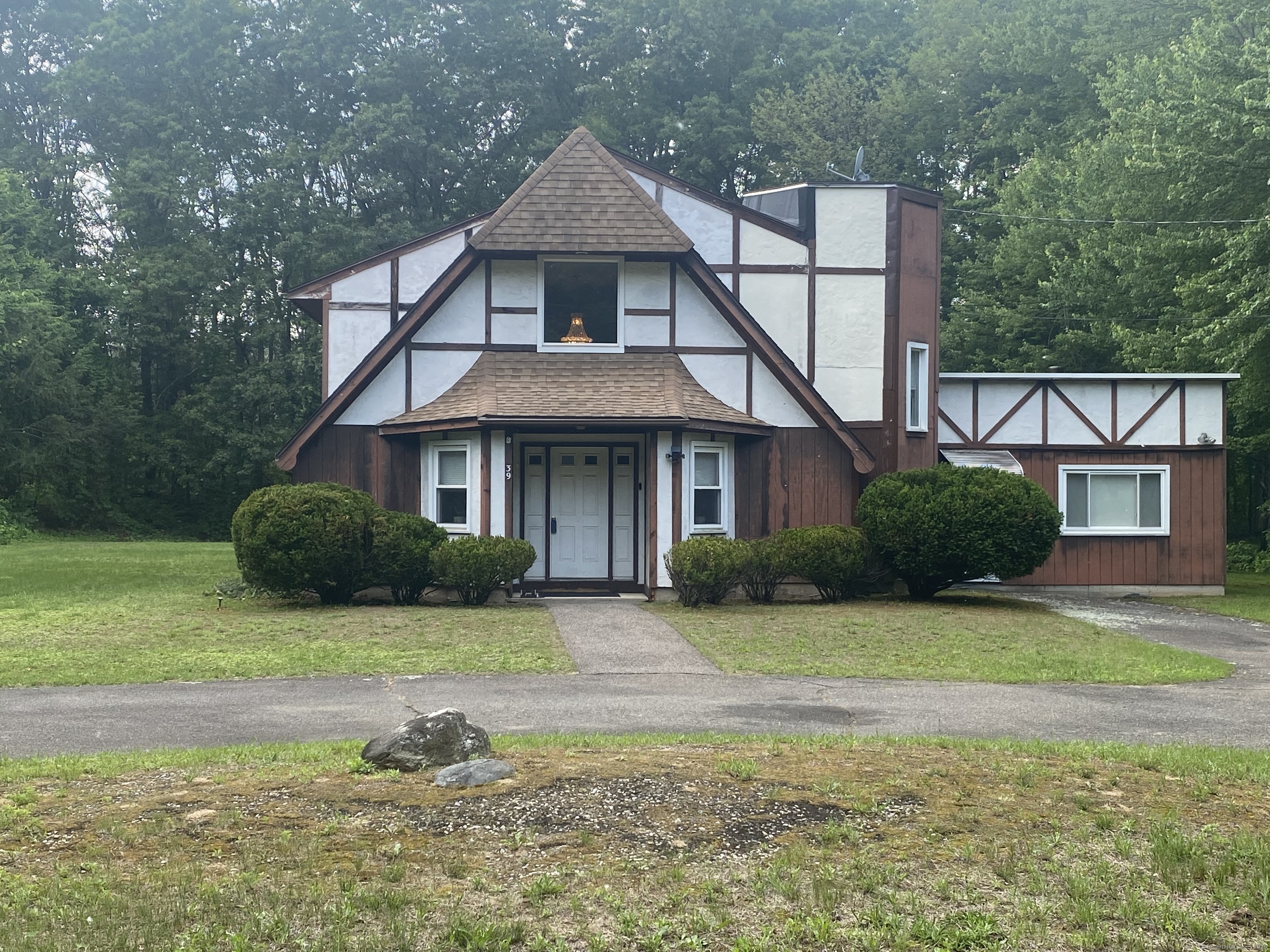 39 Loren Circle Windsor, CT 06095 - Photo 1 of 16 a front view of a house with a yard and garage