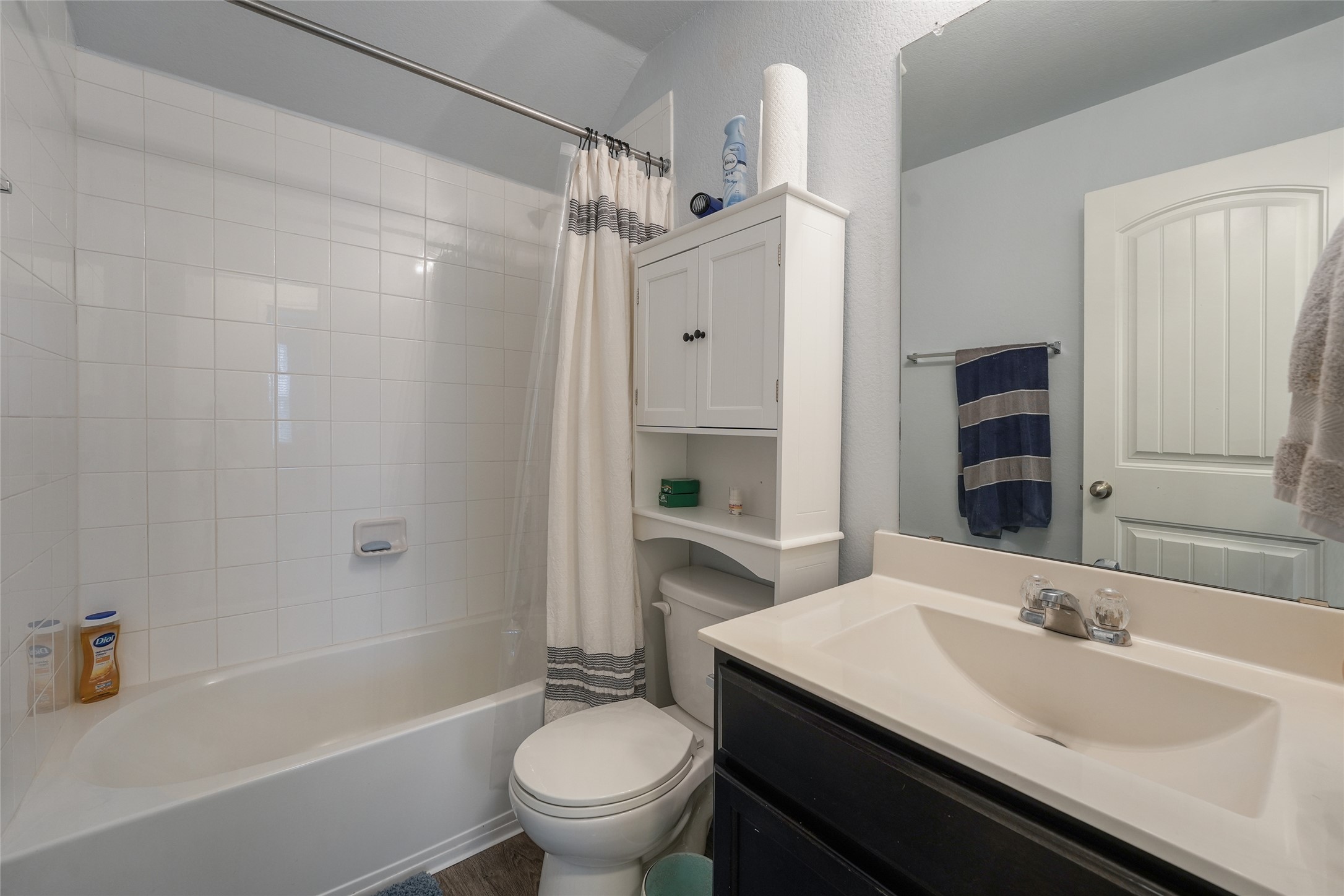15105 Shell Bark Cove Austin, TX 78724 - Photo 24 of 30 Functional full bathroom featuring a tub and shower combination with clean tile surround, complemented by a convenient vanity and mirror.