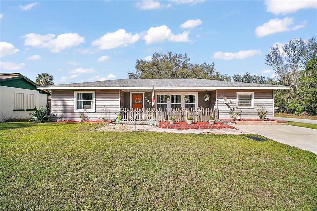102 Palm Way Tavares, FL 32778 - Photo 1 of 1 front view of a house with swimming pool having outdoor seating