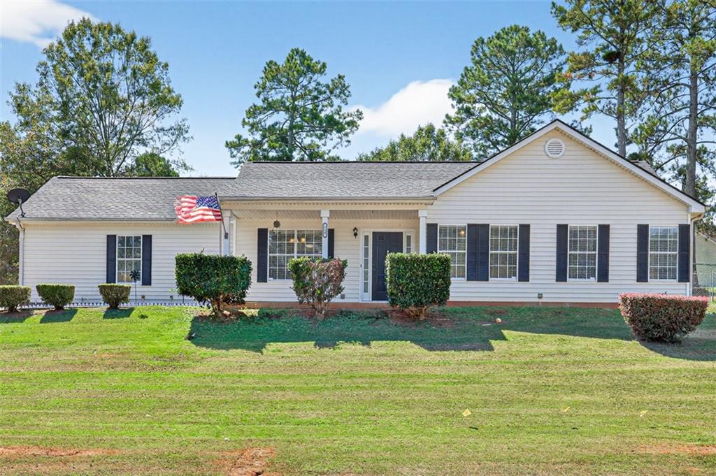a front view of house with yard and outdoor seating