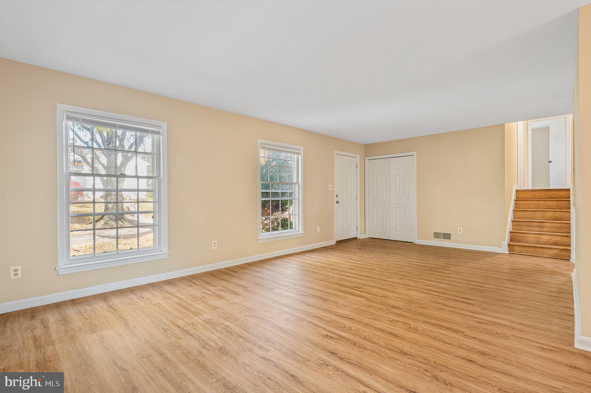 9713 Byeforde Road Kensington, MD 20895 - Photo 16 of 56 an empty room with wooden floor and windows