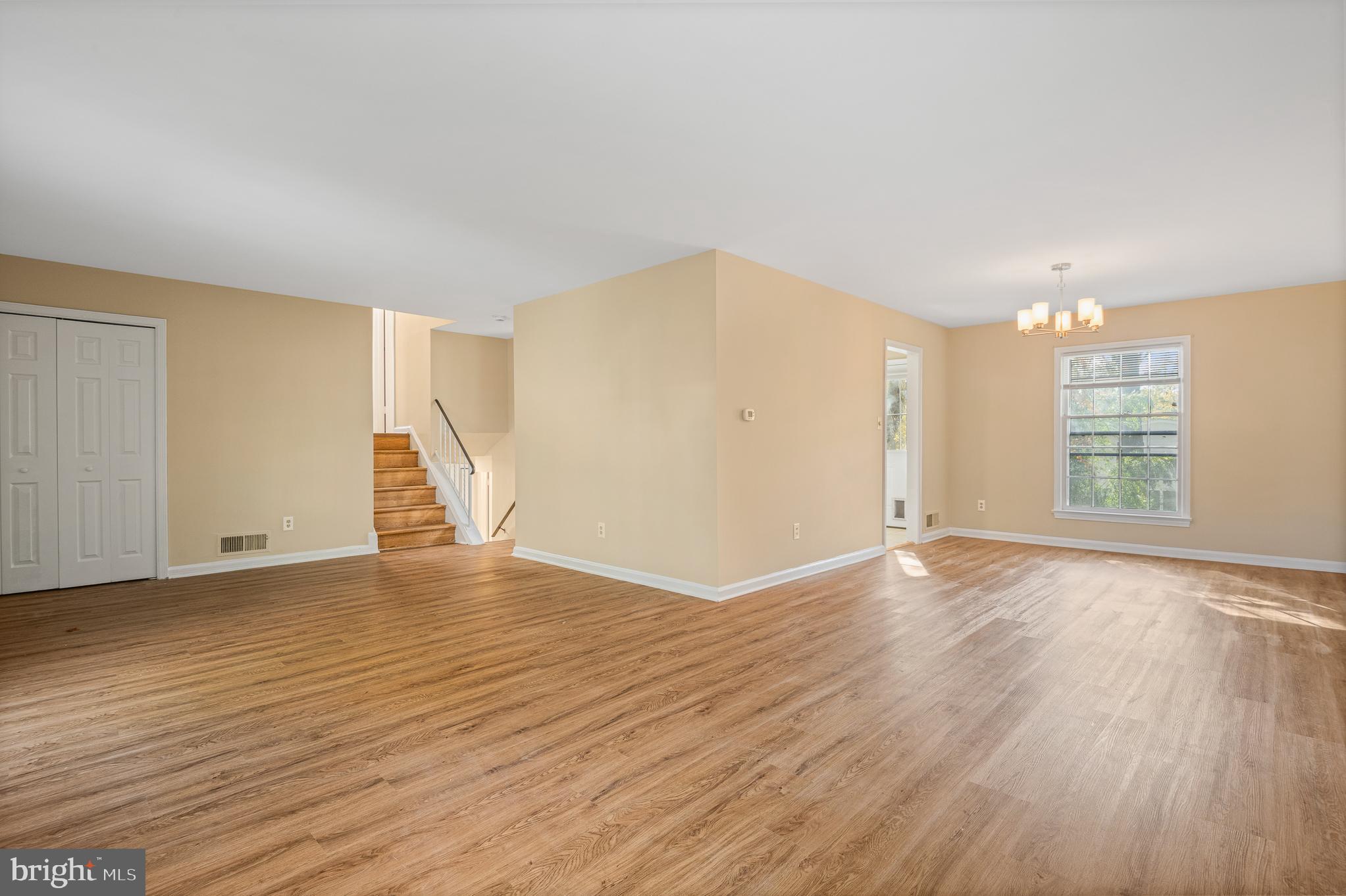9713 Byeforde Road Kensington, MD 20895 - Photo 17 of 56 an empty room with wooden floor and windows
