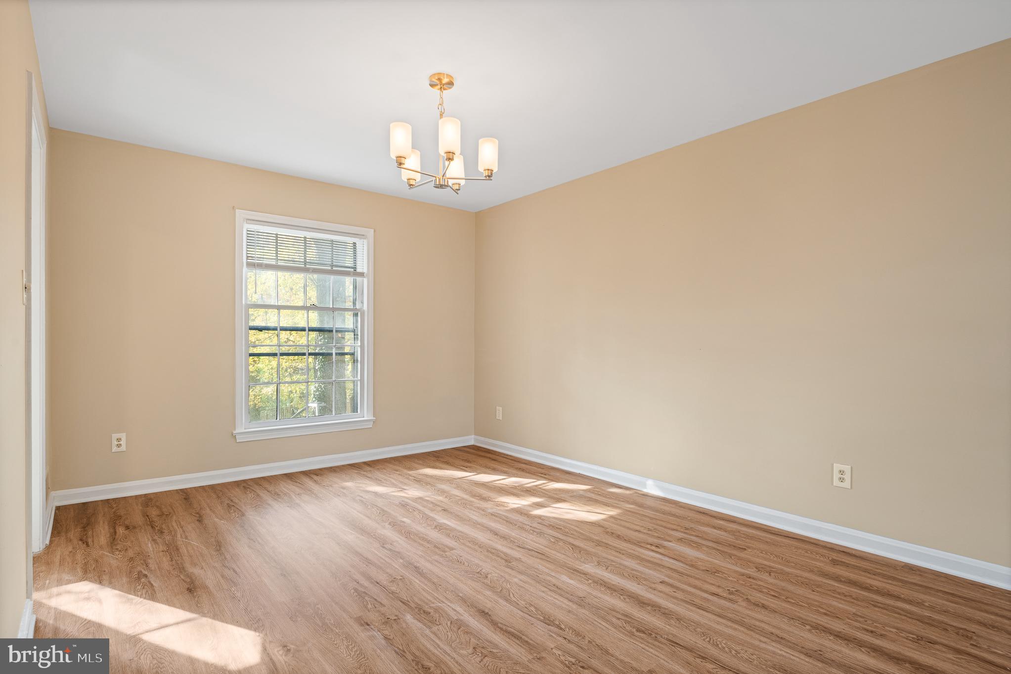 9713 Byeforde Road Kensington, MD 20895 - Photo 20 of 56 an empty room with wooden floor and window