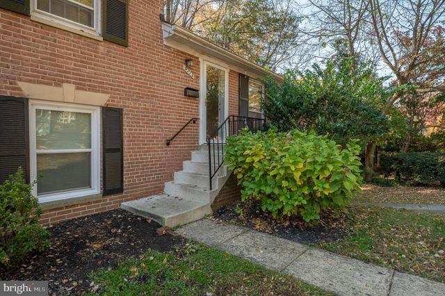 a view of a pathway of a house with potted plants