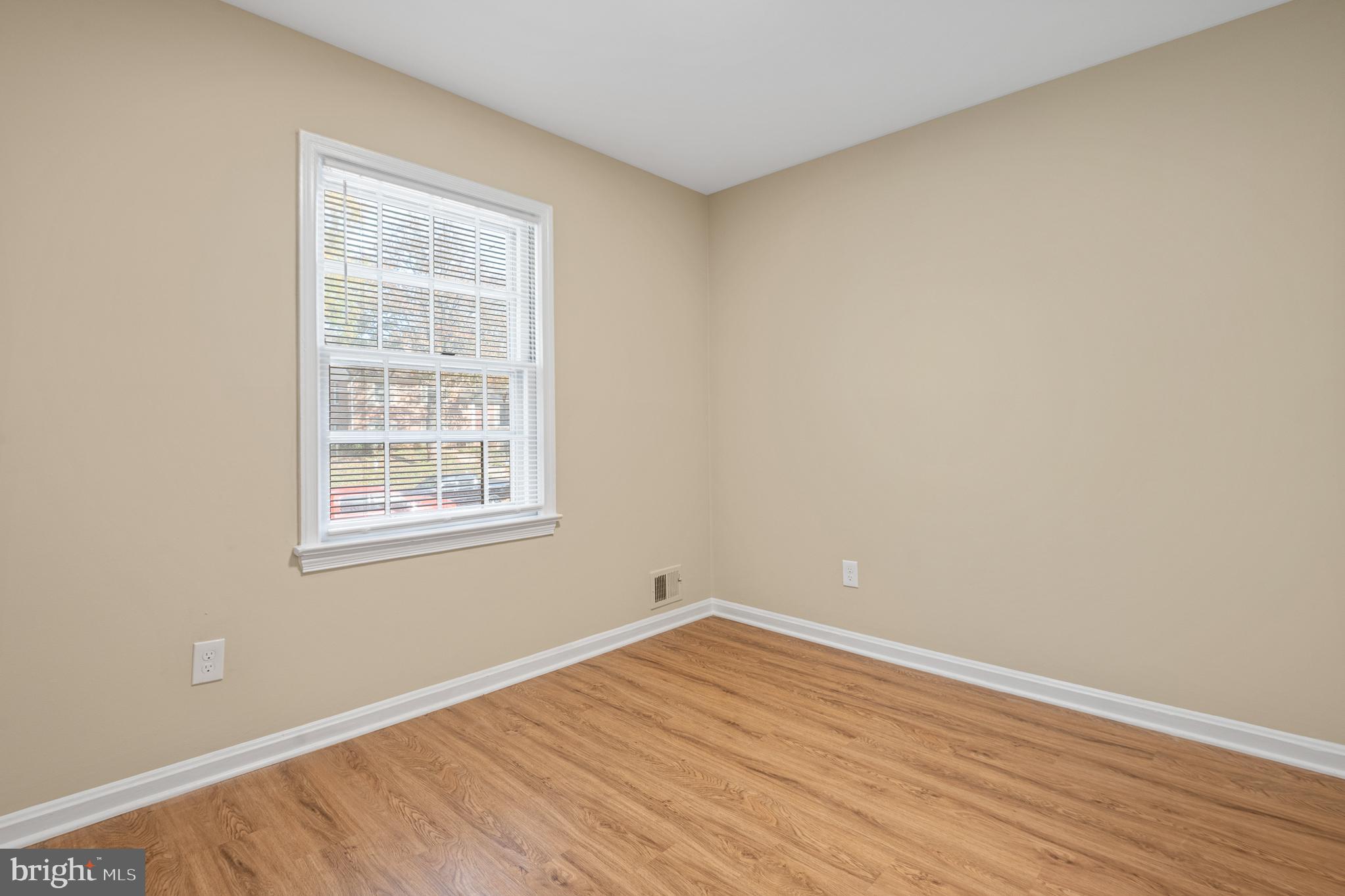 9713 Byeforde Road Kensington, MD 20895 - Photo 21 of 56 an empty room with wooden floor and windows